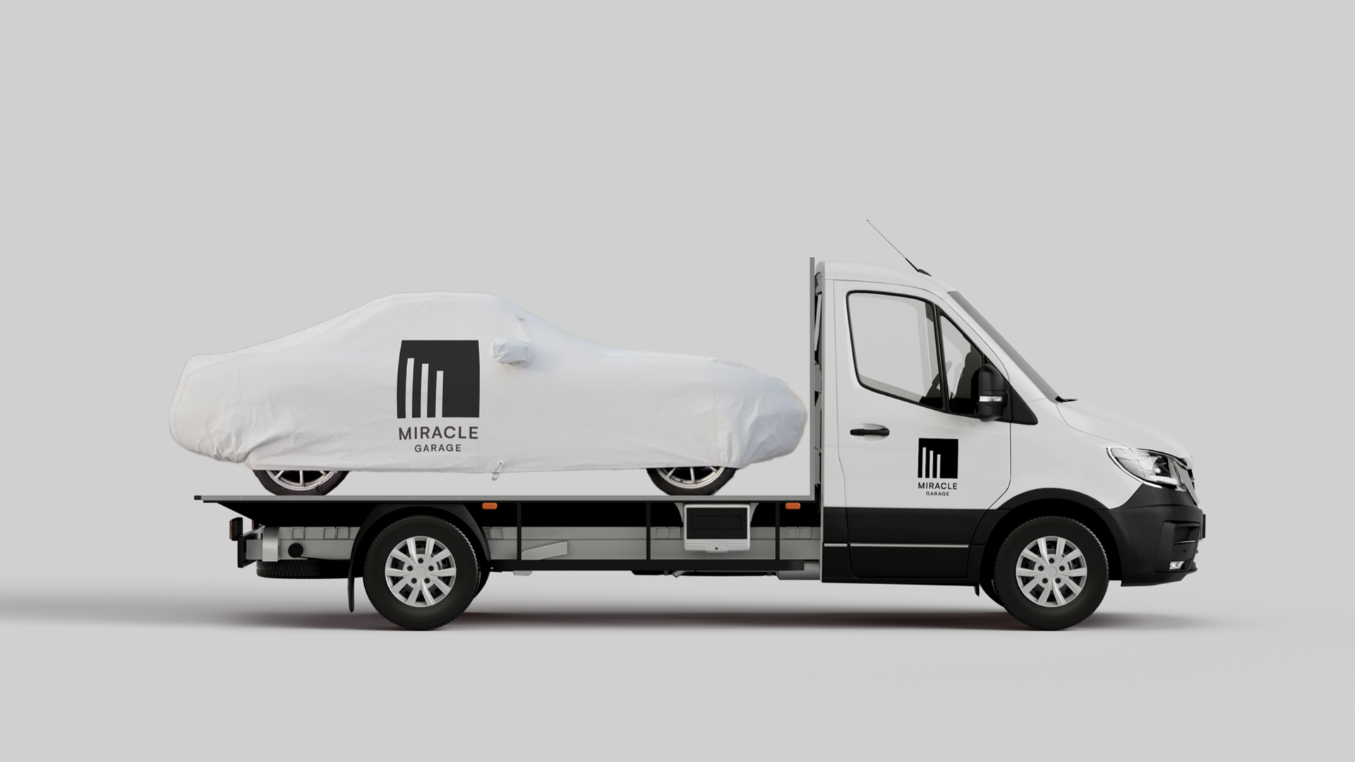 slide 33. A white truck with black Miracle Garage logo on it.